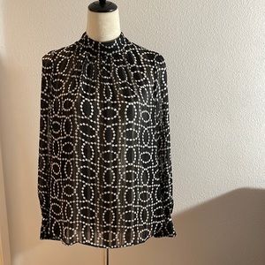 H&M black and white sheer blouse with button neckline and cuffs